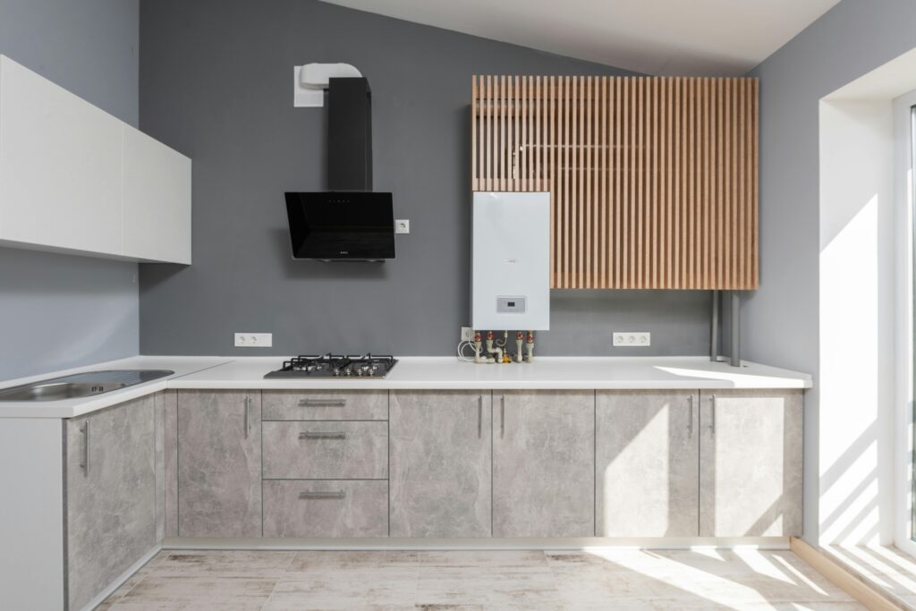Bright modern kitchen interior design with appliances and cabinetry.